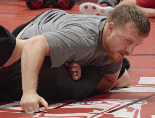 RICHMOND COACH Cody Hogan demonstrates some wrestling techniques.