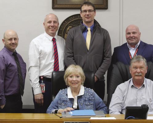 RAY COUNTY COMMISSIONERS and school district leaders review and sign agreements establishing county funding for D.A.R.E. and drug prevention education in local schools. MIRANDA JAMISON | Staff