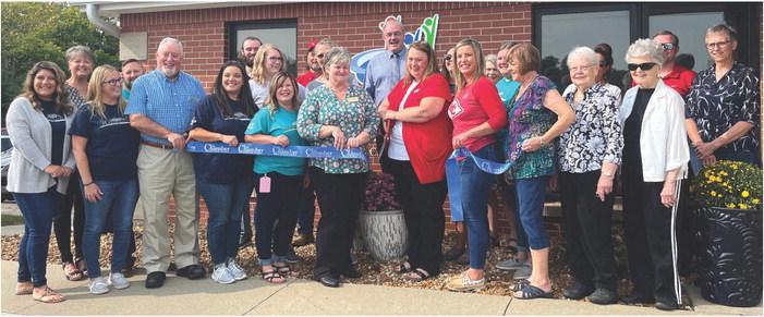 CMCCU branch manager Felicia Farabee, center, cuts the ribbon on the newly remodeled credit union facility during a Sept. 15 grand reopening event. SOPHIA BALES | Staff