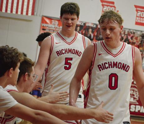 BRODY FARNAN (center) and Nolan Quick (right) exchange low fives with their teammates as they leave the court during the second half of Richmond’s courtwarming meeting with Lexington. SHAWN RONEY | Staff