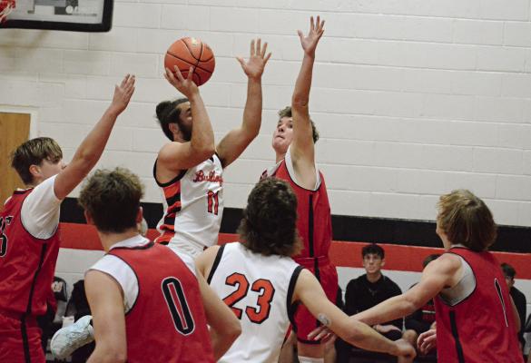 HARDIN-CENTRAL SENIOR Denver Douglas (No. 11) attempts a one-handed, first-half jump shot.