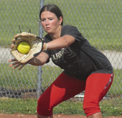 DANI DUNKIN snags a throw to first base during NHC softball practice Aug. 15 at Norborne.