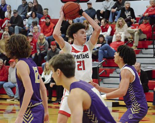 GABE JOHNSON protects the basketball by keeping it above his head as he looks to pass during the second half of Richmond’s Winter Classic title game with Bishop LeBlond of St. Joseph Jan. 27 at Richmond High School. SHAWN RONEY | Staff