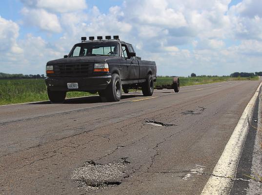 THIS DAMAGE is visible on Route J in southern Ray County. The surface, like surfaces on roads across the Northland, suffers from numerous cracks and potholes, with some of the wear being due to blowups, Missouri Department of Transportation information states. J.C. VENTIMIGLIA | Staff