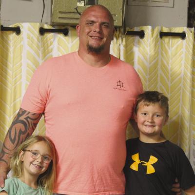 RICHMOND UNITED METHODIST CHURCH’S newest leader, Colin Brown (center), brings his children, Ellie and Willie, to meet the team at the Richmond News. SHARON DONAT | Staff