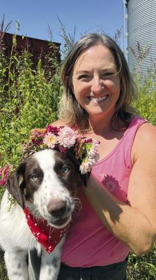 BETH FORTIN, owner of Little Green Garden LLC since 2017, got inspired by her own backyard. Fortin is shown here with her puppy, Delta. SOPHIA BALES | Staff