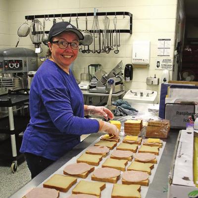 SANDWICHES are made with care and efficiency by cafeteria worker Debra Doss.