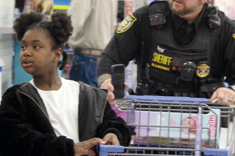 ROYALTY (LEFT) and RCSO Deputy Brian Lackey begin shopping.
