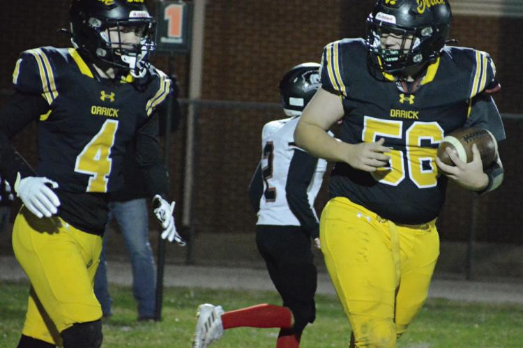ORRICK JUNIOR Reese McCartney (left) gives a look to teammate Levi Fielder after catching a two-point conversion pass late in the Bearcats’ district victory over Northland Christian. SHAWN RONEY | Staff