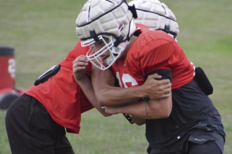 THE SPARTANS drill to prepare for their meeting with Knob Noster in varsity 11-man football. SHAWN RONEY | Staff
