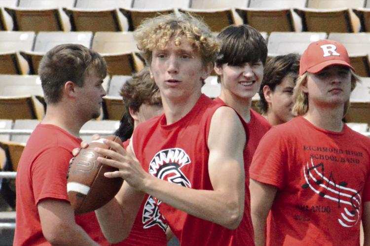 TAKING REPS at quarterback, Jacob Johnson looks to his right for a potential receiver during 7-on-7 scrimmaging Tuesday morning at Tiger Stadium in Excelsior Springs as some of his Richmond teammates watch. SHAWN RONEY | Staff