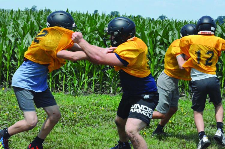 BLOCKING IS one of the skills Orrick’s varsity football players practice during a junior high and varsity camp session Monday on the practice field. SHAWN RONEY | Staff