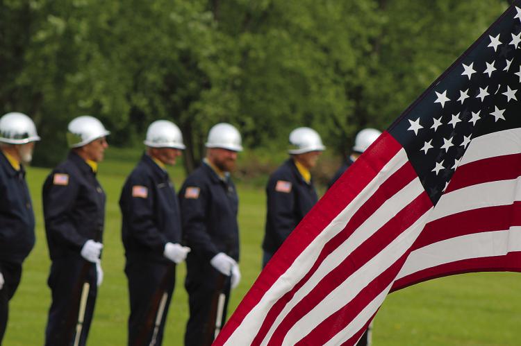 SHARON DONAT | Staff AN AMERICAN FLAG waves in front of the honor guard as the ceremony begins.