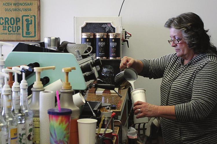 SERENDIPITY co-owner Kathy Fitzwater works to create chai latte, a blend that includes black tea and milk, which originated centuries ago in India.