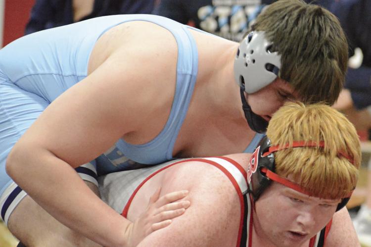 LANDON GARRETT of Richmond looks to get up from the bottom position during his match with Archer Cavanah of Father Tolton Regional Catholic. SHAWN RONEY | Staff