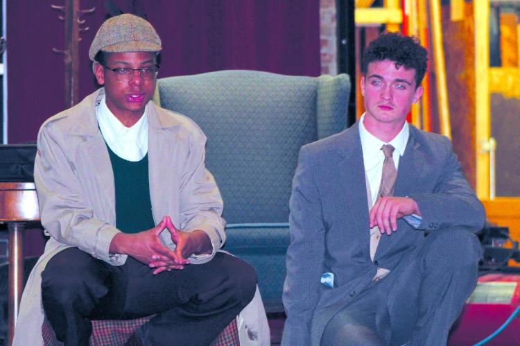 ZAVIER DAVIS (left) as Sherlock Holmes looks for clues with Jazspher Ulleburg playing Watson during RHS spring play rehearsal at the Farris Theatre. “Holmes and Watson: The Game’s Afoot” will be presented March 13 and 14 at 7:00 p.m. and 2:00 p.m. on Sunday March 15. SHARON DONAT | Staff