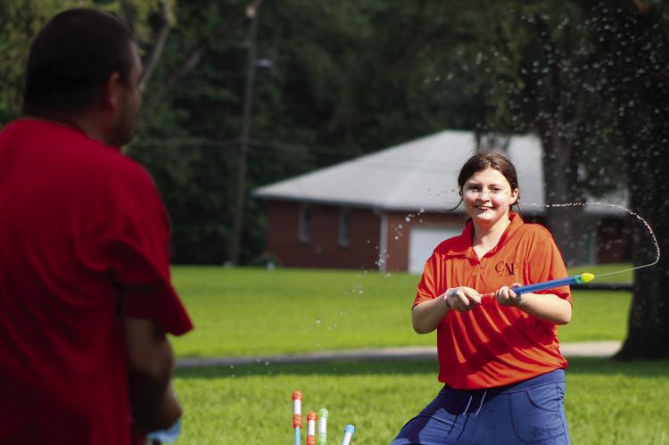 WITH A FULL arsenal of water blasters nearby, Ellis Arnold takes aim. SHARON DONAT | Staff