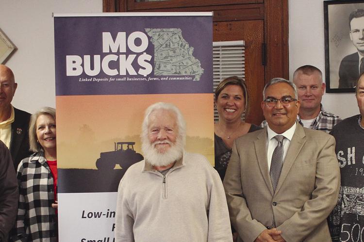 COUNTY LEADERS and state representatives discuss the MOBUCK$ program. SOPHIA BALES | Staff