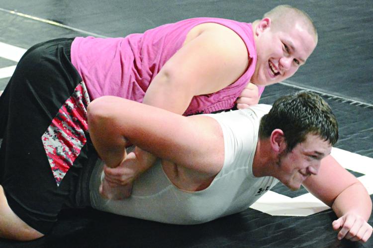 SEBASTIAN SVEISTRUP (top) and Travis Cardwell seem to be having fun as they practice their wrestling moves. SHAWN RONEY | Staff
