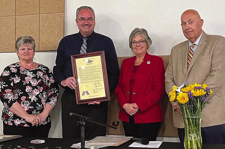 FROM LEFT: Renee Kellerman, Brian Rice, Peggy McGaugh and Terry Thompson face the crowd during the chamber’s 75th anniversary celebration as the two state representatives congratulate their accomplishments with a proclamation from the state. SOPHIA BALES | Staff