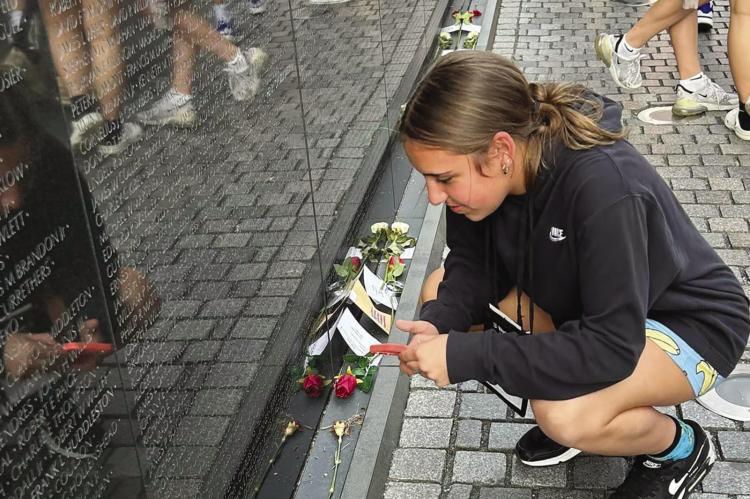 ADDISON BECK reads names of the fallen at the Vietnam War Memorial. BRENDA HAMM | Submitted