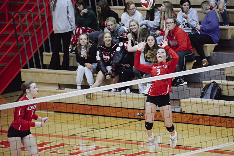 WITH FELLOW SPARTAN Kelly Jaggars, left, and some spectators watching, Richmond first-year high schooler Genevieve Didier leaps to make a touch pass Oct. 20 during Richmond’s season-ending road loss to Oak Grove in Class 3 District 15 Tournament play. SHAWN RONEY | Staff