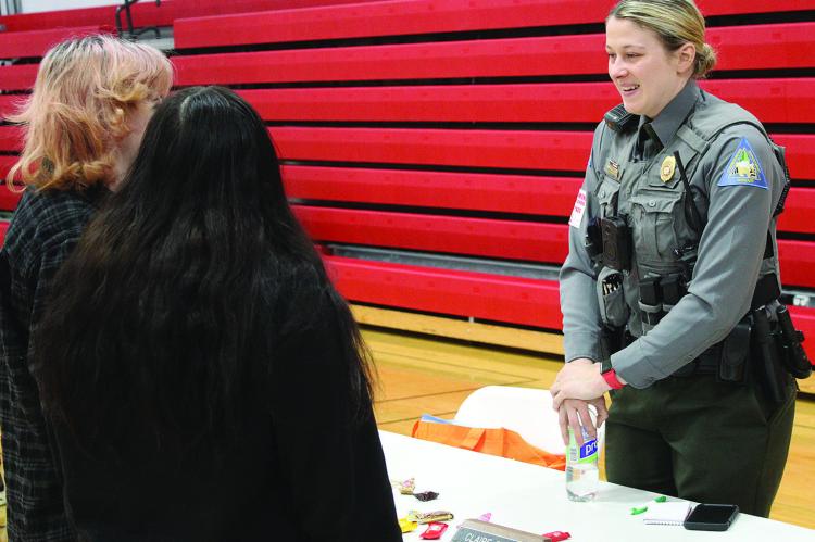 MISSOURI CONSERVATION DEPARTMENT Officer Claire Burch explains her role to students at the Richmond High School job fair. SHARON DONAT | Staff