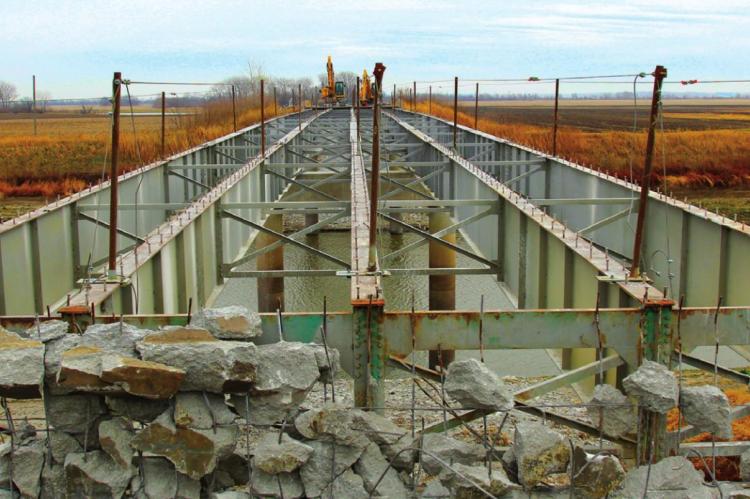 STRIPPING the Route J bridge deck for replacement exposes steel ribs and the Crooked River below. J.C. VENTIMIGLIA | Staff