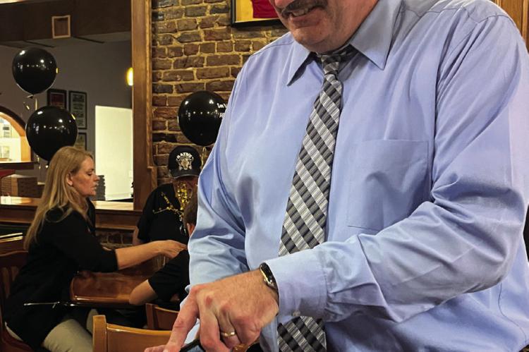 FORMER PUBLISHER of the Richmond News and Excelsior Springs Standard Brian Rice cuts his retirement cake. Rice has begun a new journey as president of the Excelsior Springs Area Chamber of Commerce. SOPHIA BALES | Staff