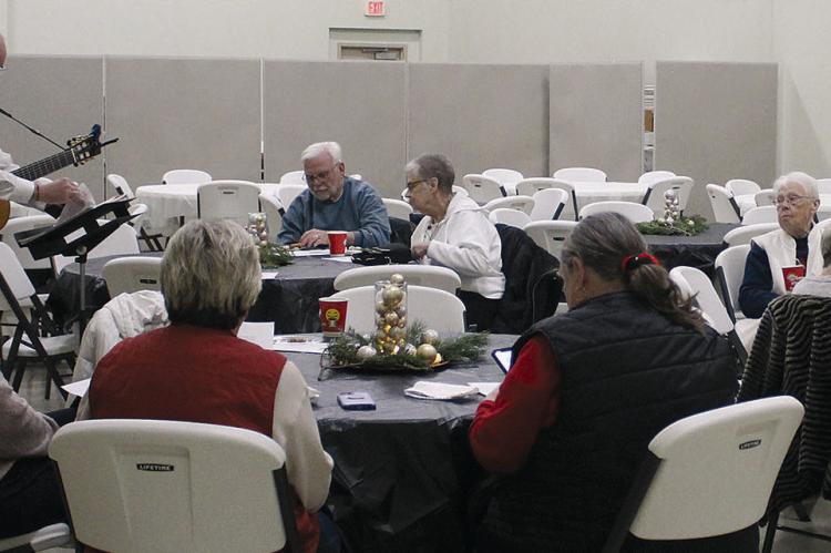 UNITED CHRISTIAN PRESBYTERIAN CHURCH Pastor Paul Grant leads the crowd in Christmas carols. SHARON DONAT | Staff