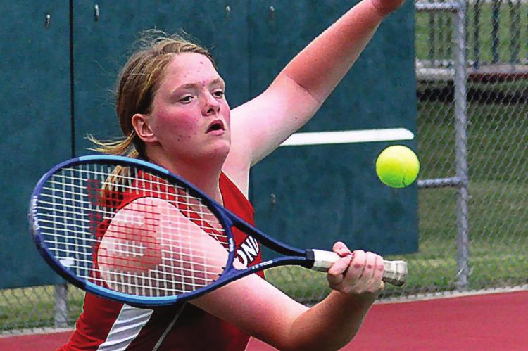 SOPHOMORE TAYLOR McGLOTHLIN hits a backhand shot during her No. 1 singles match Tuesday as she and her fellow Spartans host Carrollton in a varsity dual at Maurice Roberts Park. SHAWN RONEY | Staff