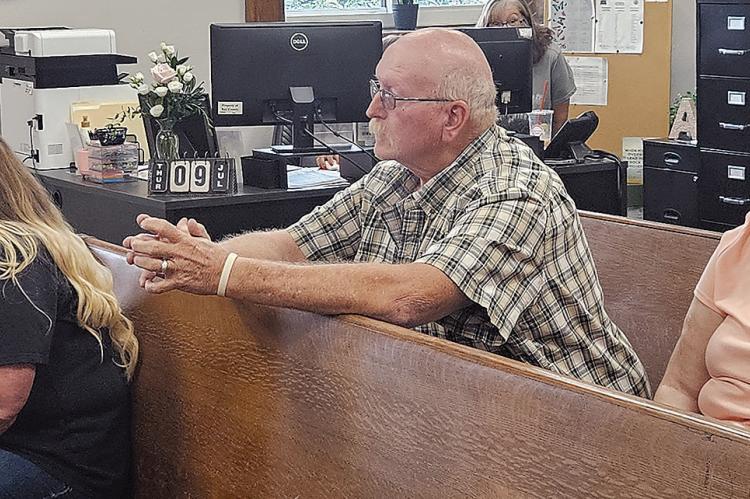MICHAEL VASSMER (center) and his wife discuss proposed amendments to the conditional use permit for their trap shooting range. Ray County Planning and Zoning Assistant Administrator Paula Patchett (left) voiced support for allowing the range to operate seven days a week. MIRANDA JAMISON | Staff