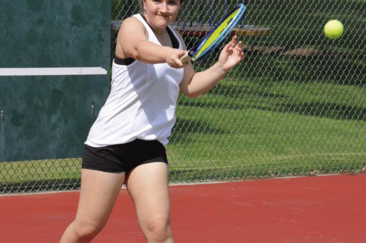 RAEGAN ALDERSON returns a shot from the baseline as the Richmond girls tennis team practices Aug. 10 at Maurice Roberts Park.