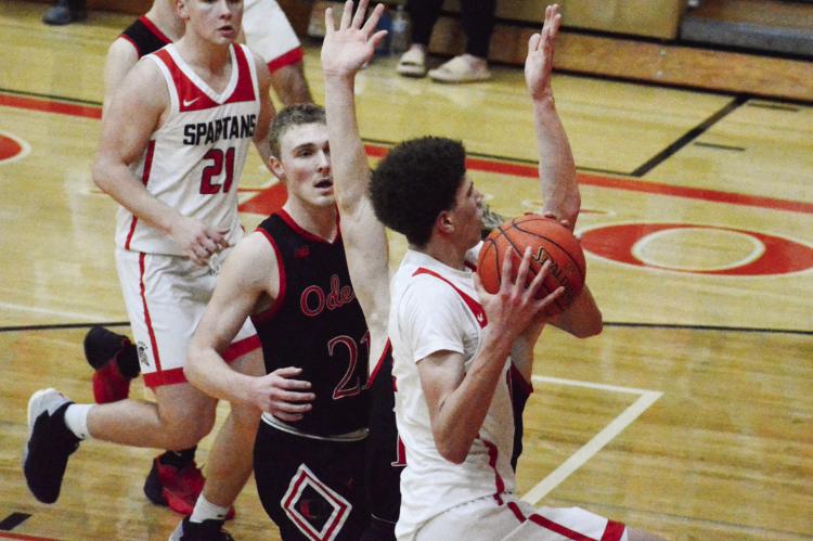 RICHMOND SOPHOMORE Gabe Johnson drives to attempt a second-half layup during the Spartans’ 51-48 loss to Odessa in the Class 4 District 15 title game March 3 at Oak Grove. SHAWN RONEY | Staff