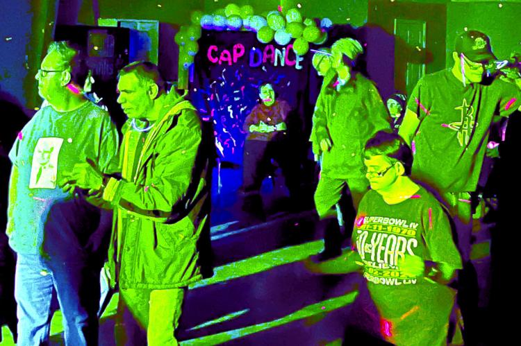 VIVID COLORED LIGHTS and well-known music engage attendees at the Community at Play (CAP) dance. Many dance the night away as CAP continues to gather feedback from our area residents and community members. SOPHIA BALES | Staff
