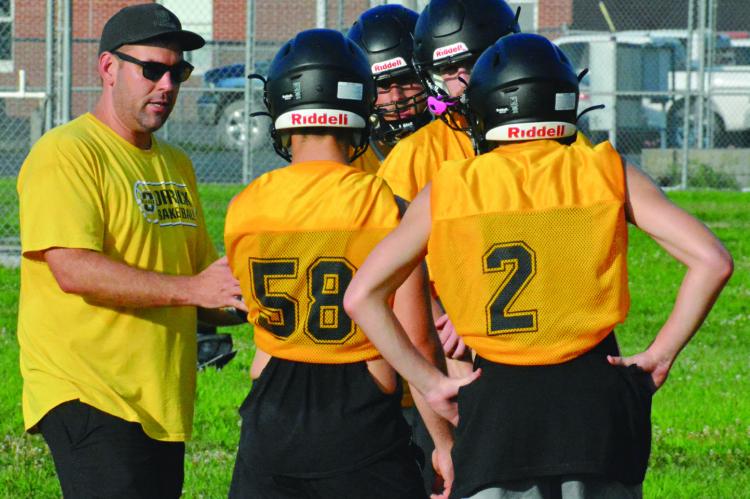 ORRICK VARSITY EIGHT-MAN football coach Matt O’Dell (left) and his Bearcats are helping to make July a joy. SHAWN RONEY | Staff
