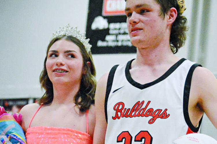 RENEE GRYMALA (left) and Kaleb Gant are crowned courtwarming queen and king, respectively, after Hardin-Central’s varsity girls and boys basketball games with Orrick. SHAWN RONEY | Staff