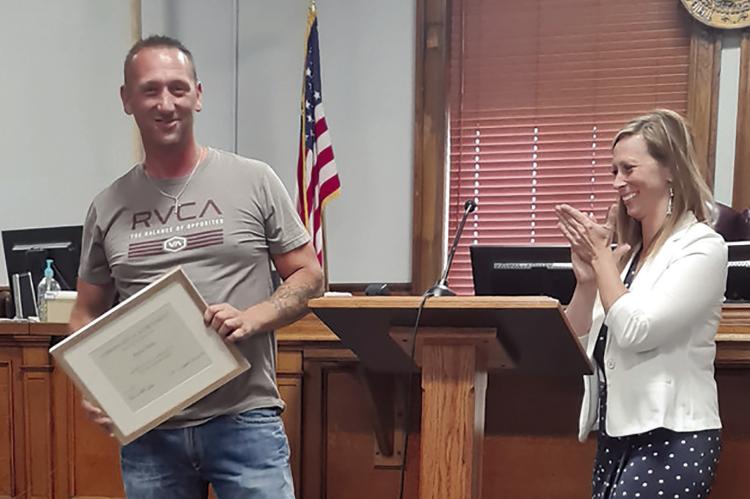 Rickie Hicks (left) graduates from the Ray County Drug Court program as Ray County Prosecutor Camille Johnston applauds his accomplishments. MIRANDA JAMISON | Staff