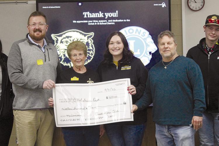 ORRICK LIONS CLUB representatives deliver funding to Orrick High School’s science department for new classroom microscopes. See page 7 for story. MIRANDA JAMISON | Staff