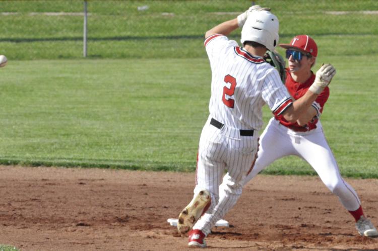 LOCHLAN STEELE (left) gets ready to slide to try to beat a throw to second base during Richmond’s 5-4 loss to Carrollton. The Spartans rebounded from the one-run May 1 defeat by edging Oak Grove 8-6 on the road, putting them at 6-11 overall entering Tuesday’s meeting with Pleasant Hill. SHAWN RONEY | Staff