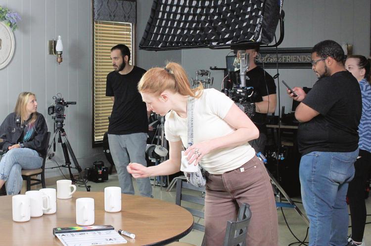 MONICA ALLEY, art director from Five Stone Studios, checks props and last-minute details on the “Farmer’s Table” set before the filming begins June 8 at Daddy’s 10-13 Diner. SOPHIA BALES | Staff