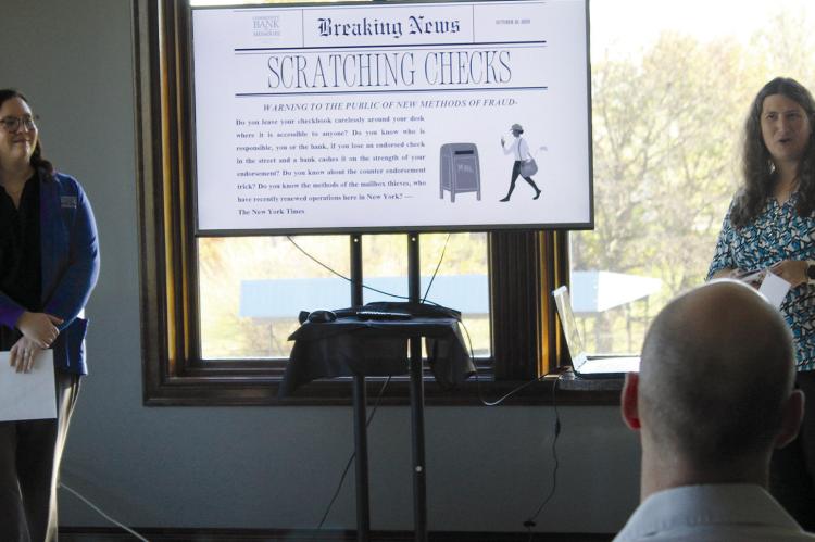 COURTANIE WOODS (left) and Erin Wyse talk about preventing fraud during a recent chamber function. SHARON DONAT | Staff