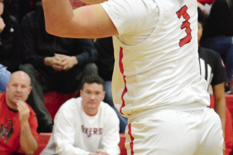 RICHMOND SENIOR Jack Gogue attempts a first-half shot Jan. 6 against visiting Pleasant Hill.