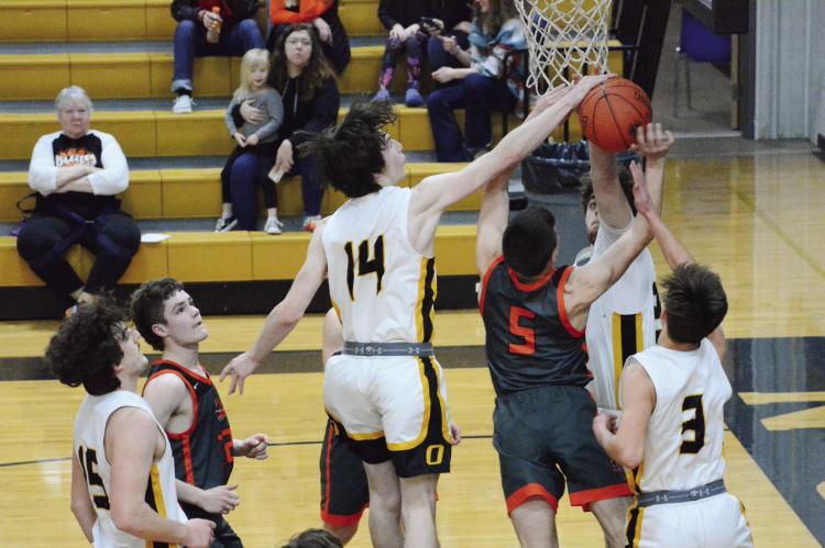 ORRICK JUNIOR Johnathon Harris, No. 14; senior Zander Stevinson, No. 3; and sophomore Tucker Greer surround and contest a second-half shot by Hardin-Central junior Kameron Pugh Feb. 24 in district play at Norborne. SHAWN RONEY | Staff