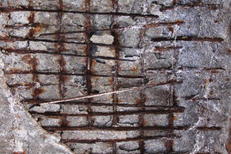 THE UNDERSIDE of the old Highway 13 overpass in Henrietta shows where concrete is missing and rebar is bared to the elements.