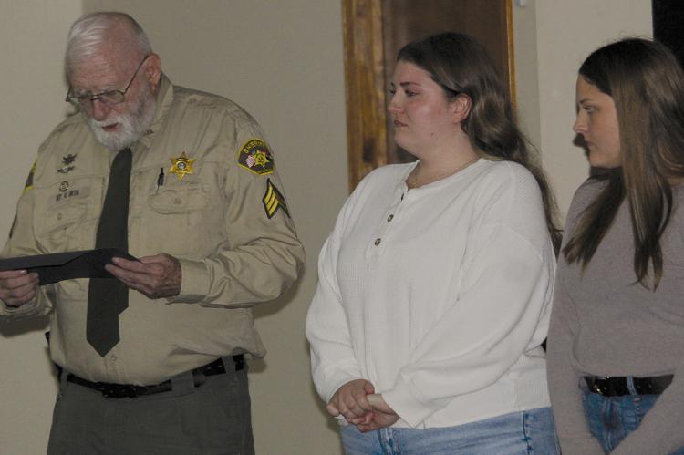 DEPUTY RAY ORTH recognizes sisters Addison (center) and Deborah Jackson after the pair helped save a 90-year-old neighbor by performing CPR and calling 911 during a medical emergency. MIRANDA JAMISON | Staff