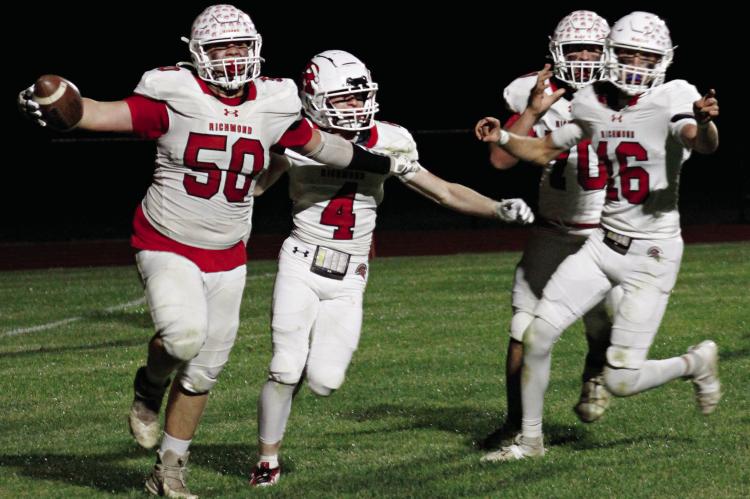 SENIOR JOHN WEBER (left) is jubilant after running in a fumble for a two-point conversion near the end of Richmond’s recent Bell Game 58-22 victory on the road against archrival Lexington. Celebrating with him are Nolan Quick (from left), James Earl and Jacob Johnson. ZANE CREASON | Staff