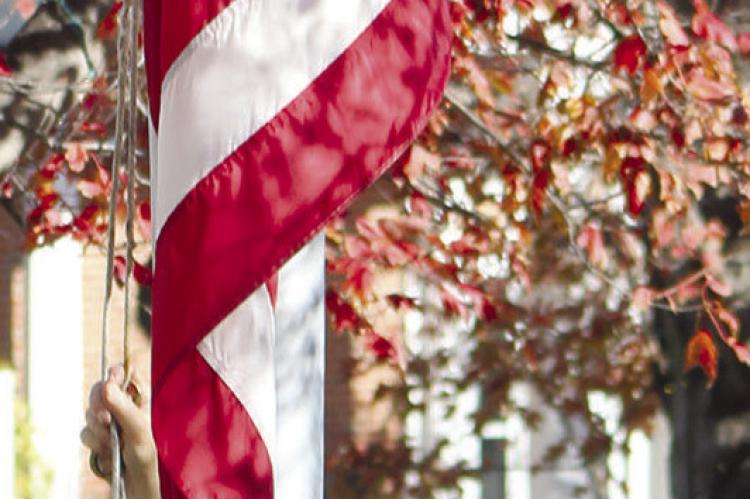 JIM RICHARDSON prepares to raise the courthouse flag during the Veteran’s Day ceremony. SHARON DONAT | Staff