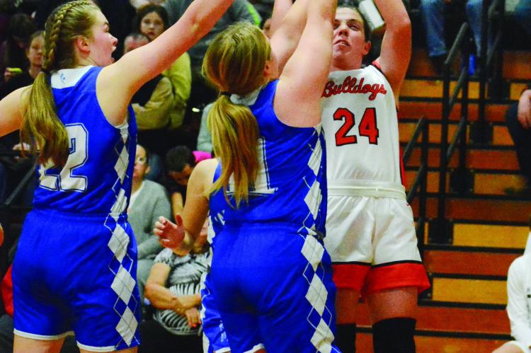 HARDIN-CENTRAL junior Libby Fifer muscles up a second-half jump shot against a double team Dec. 1 against visiting Tri-County. SHAWN RONEY | Staff