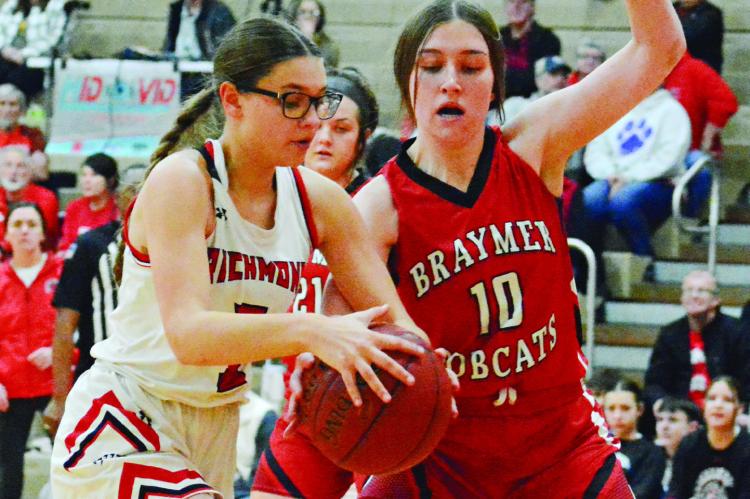 MAYA GRIFFIN keeps both hands on the basketball while being guarded by Morgan Haughton Jan. 26 in tournament action at Richmond Middle School. SHAWN RONEY | Staff